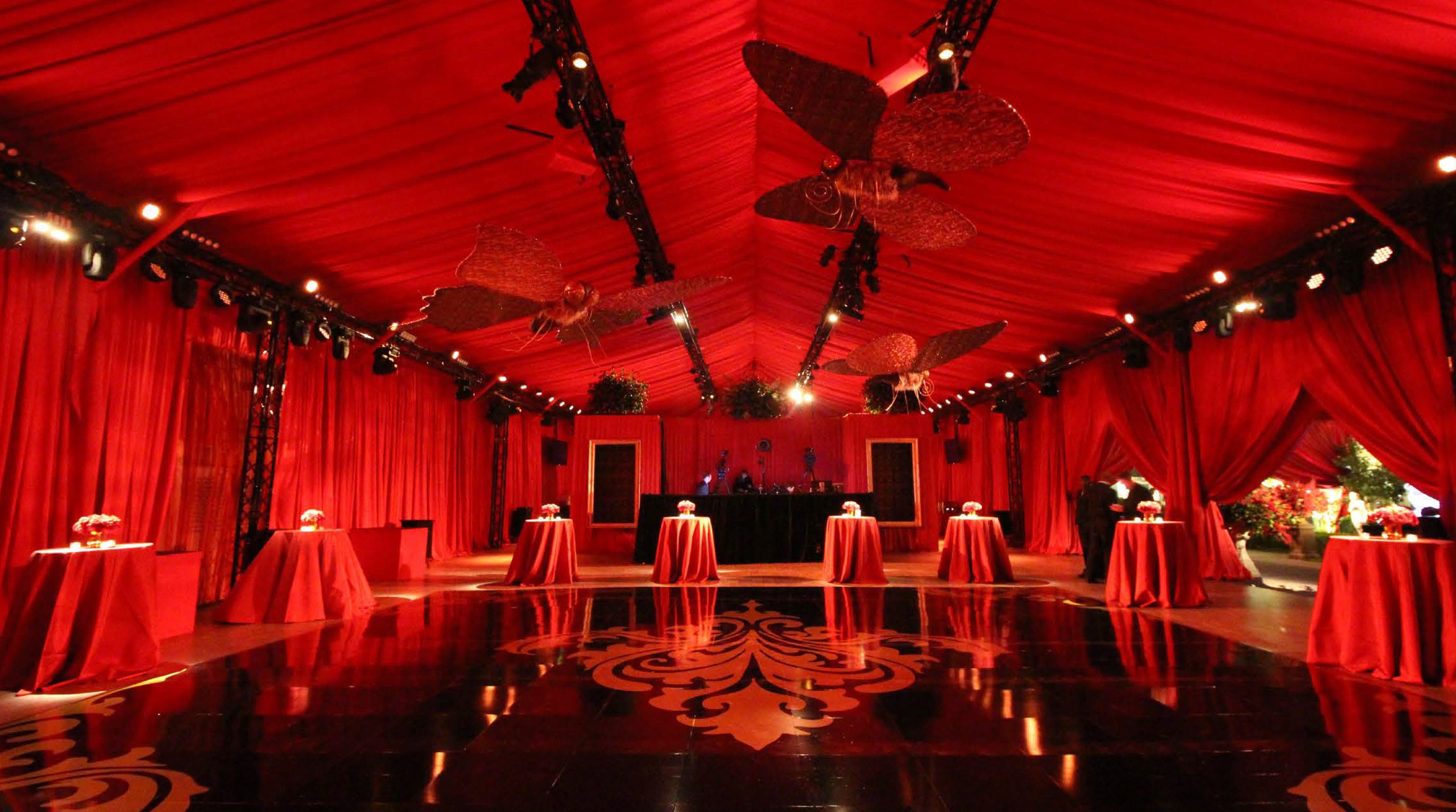 A holiday-themed room with red drape and red tables