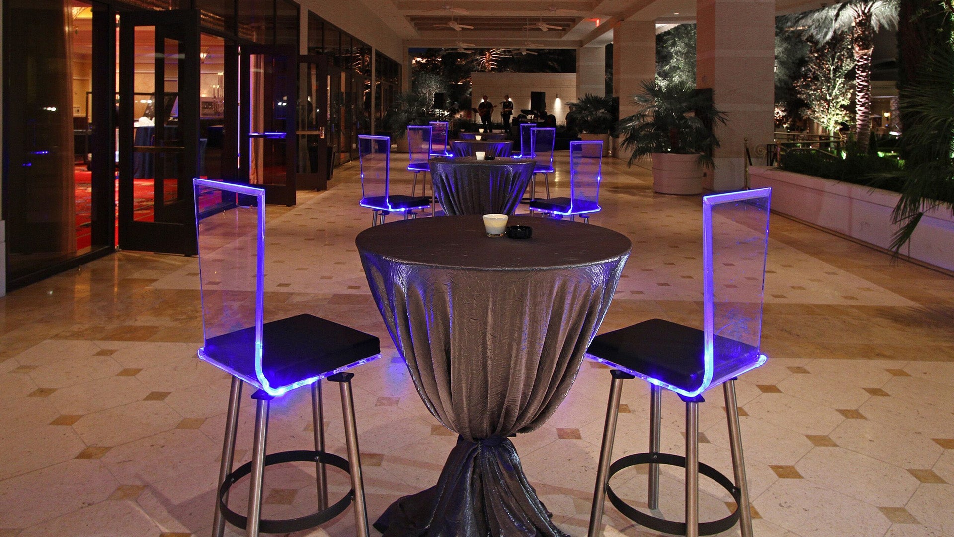 Acrylic flex chairs in a lounge setting, illuminated in blue light