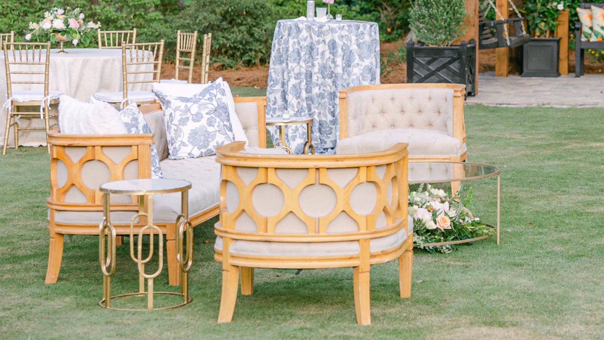 Chairs and end tables on a green lawn