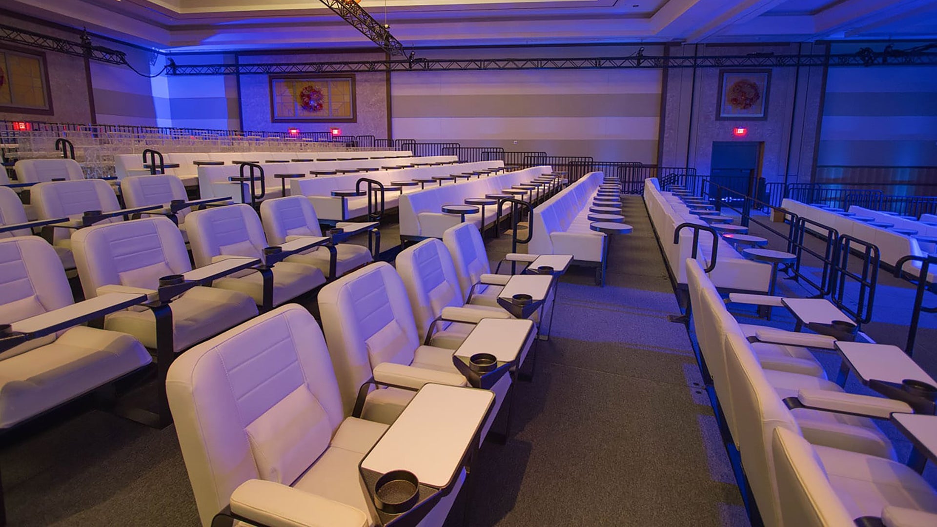 Rows of seats at a special event, lit in blue